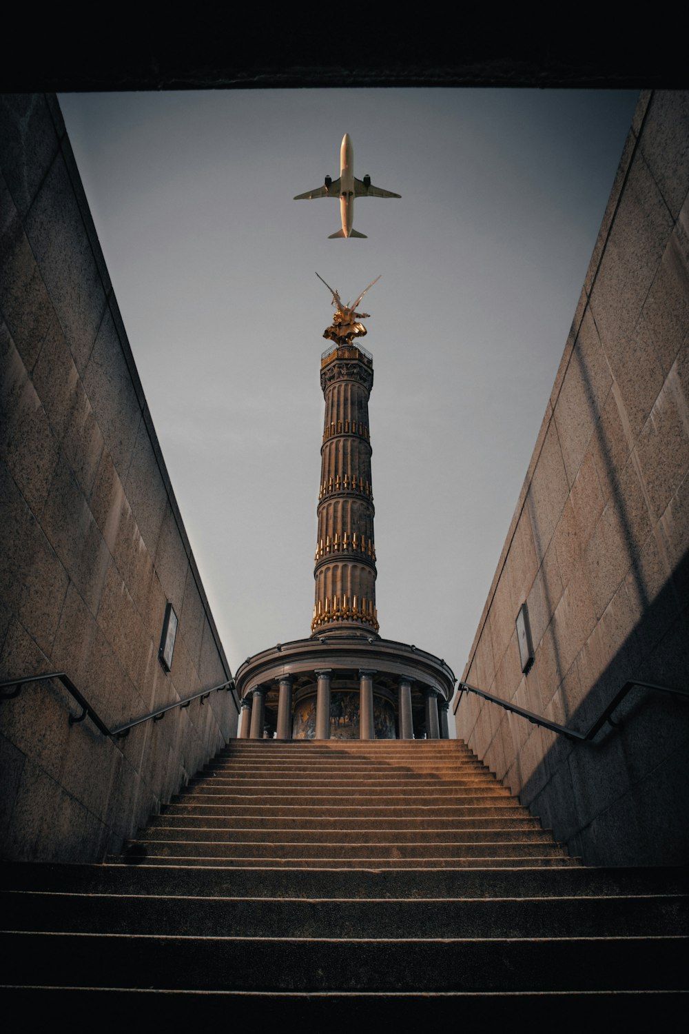 a plane is flying over a building with stairs