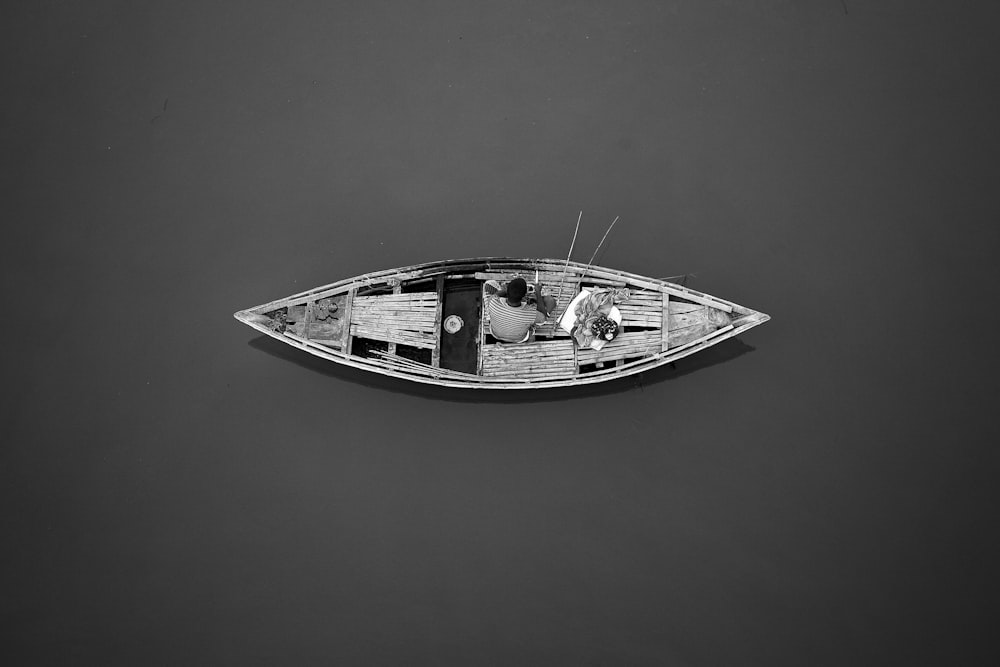 a small boat floating on top of a body of water