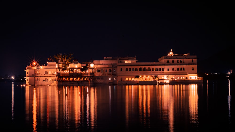 a large white building sitting on top of a lake