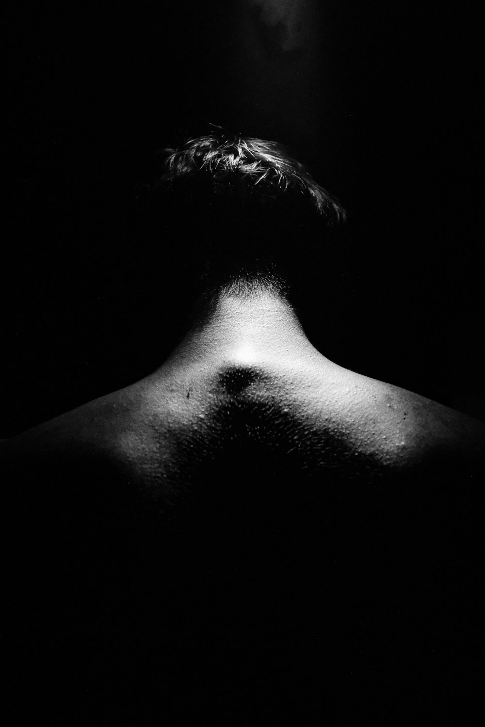 the back of a man's head in the dark