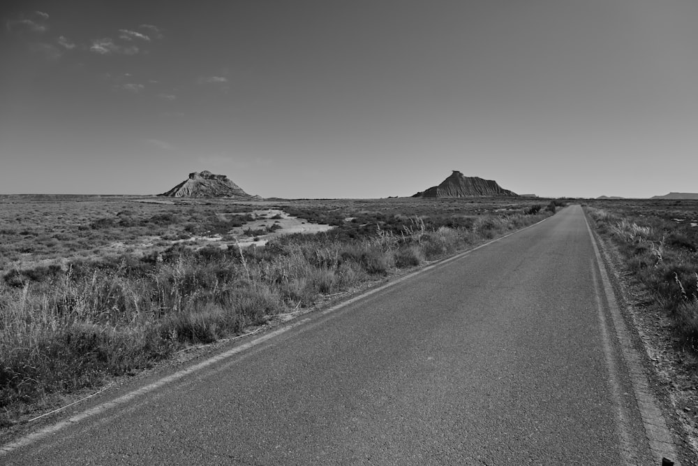 a black and white photo of a road in the middle of nowhere