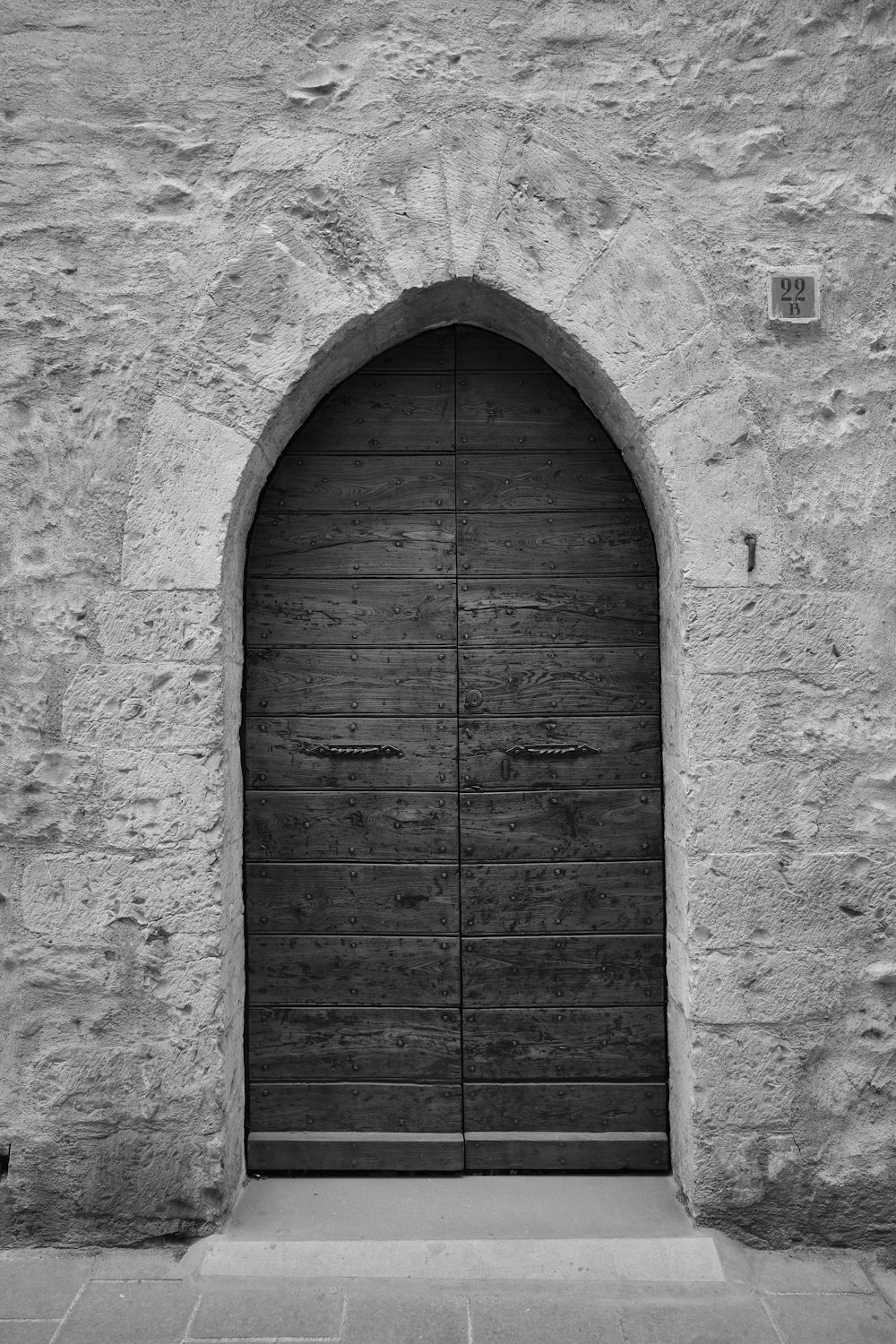 a black and white photo of a wooden door