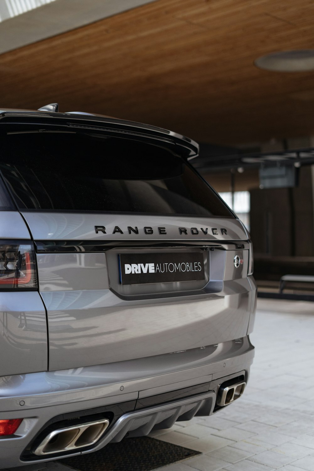 a silver range rover parked in a garage