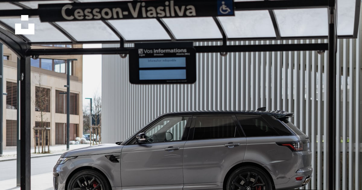 A silver range rover parked in front of a bus stop photo – Free Car ...