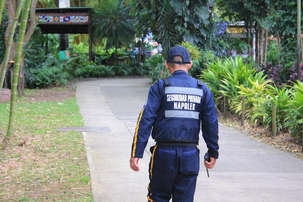 a police officer is walking down a sidewalk