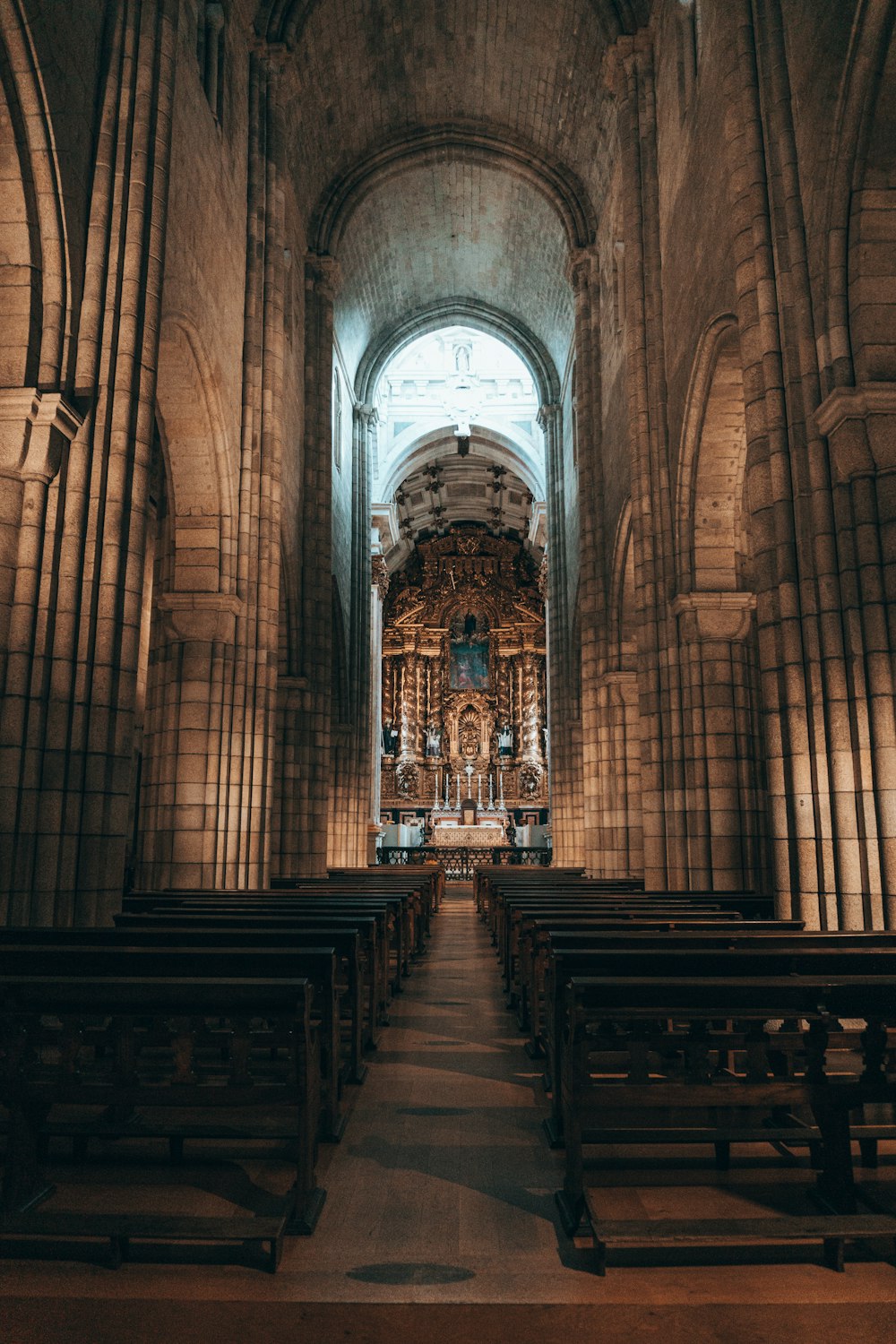 a large cathedral with pews and a clock on the wall