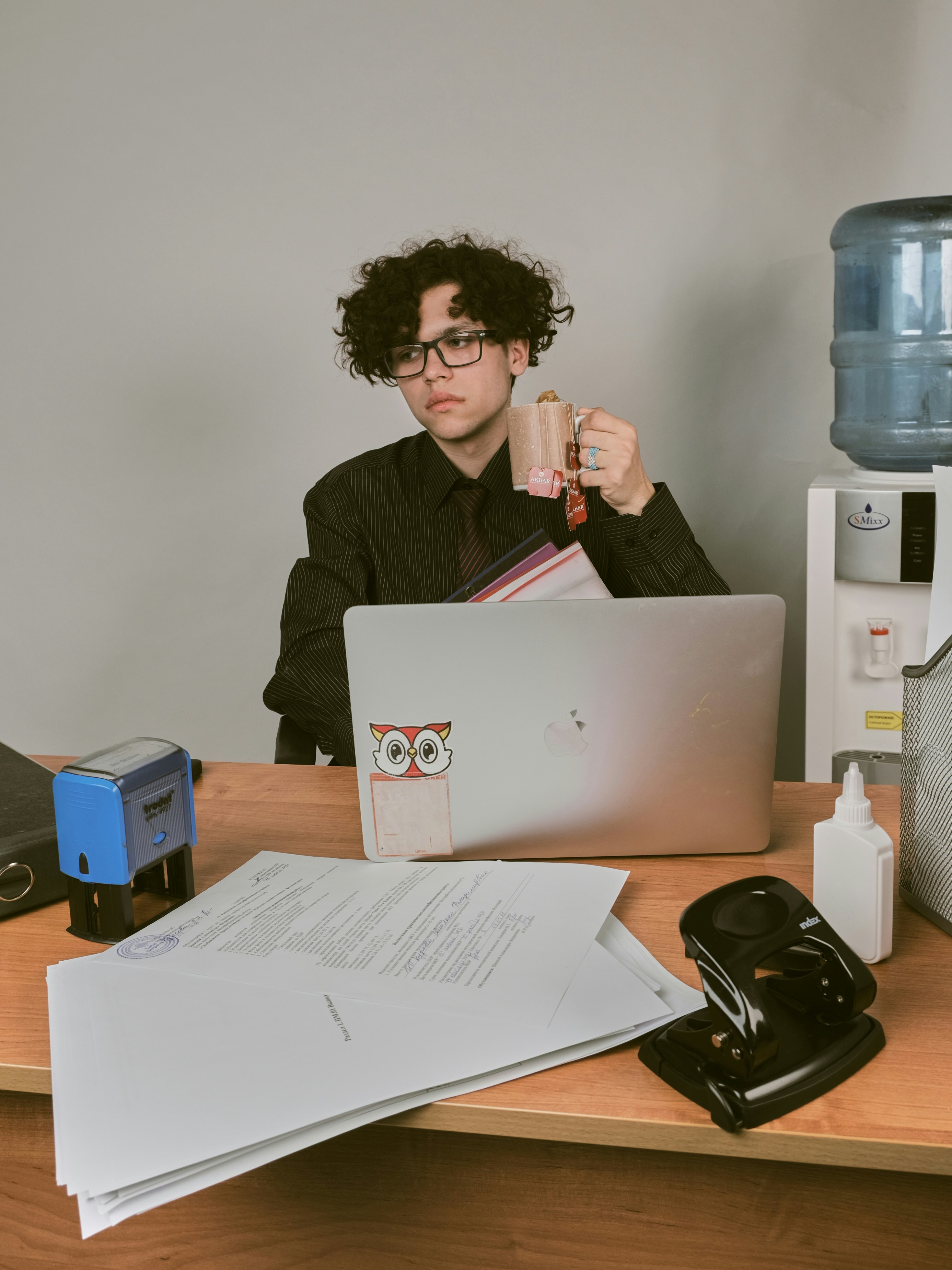 a man sitting at a desk with a laptop