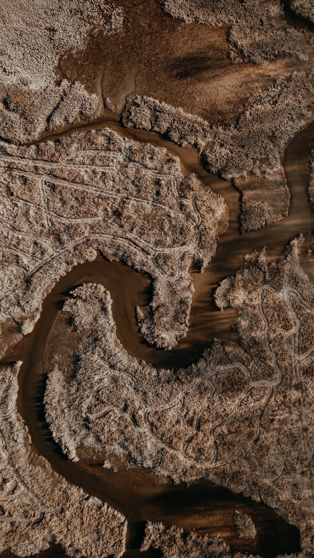 an aerial view of a river and land