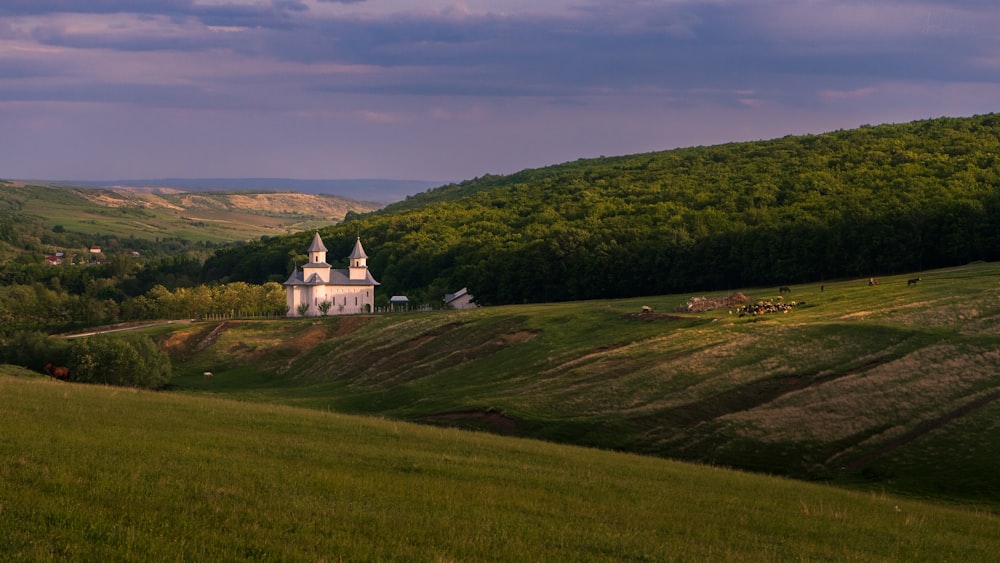 a church in the middle of a lush green valley