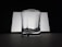 A clear, empty glass with a slightly reflective surface is positioned against a contrasting background of white and black. The lighting creates soft shadows and highlights on the glass surface, adding to its transparent and minimalistic look.