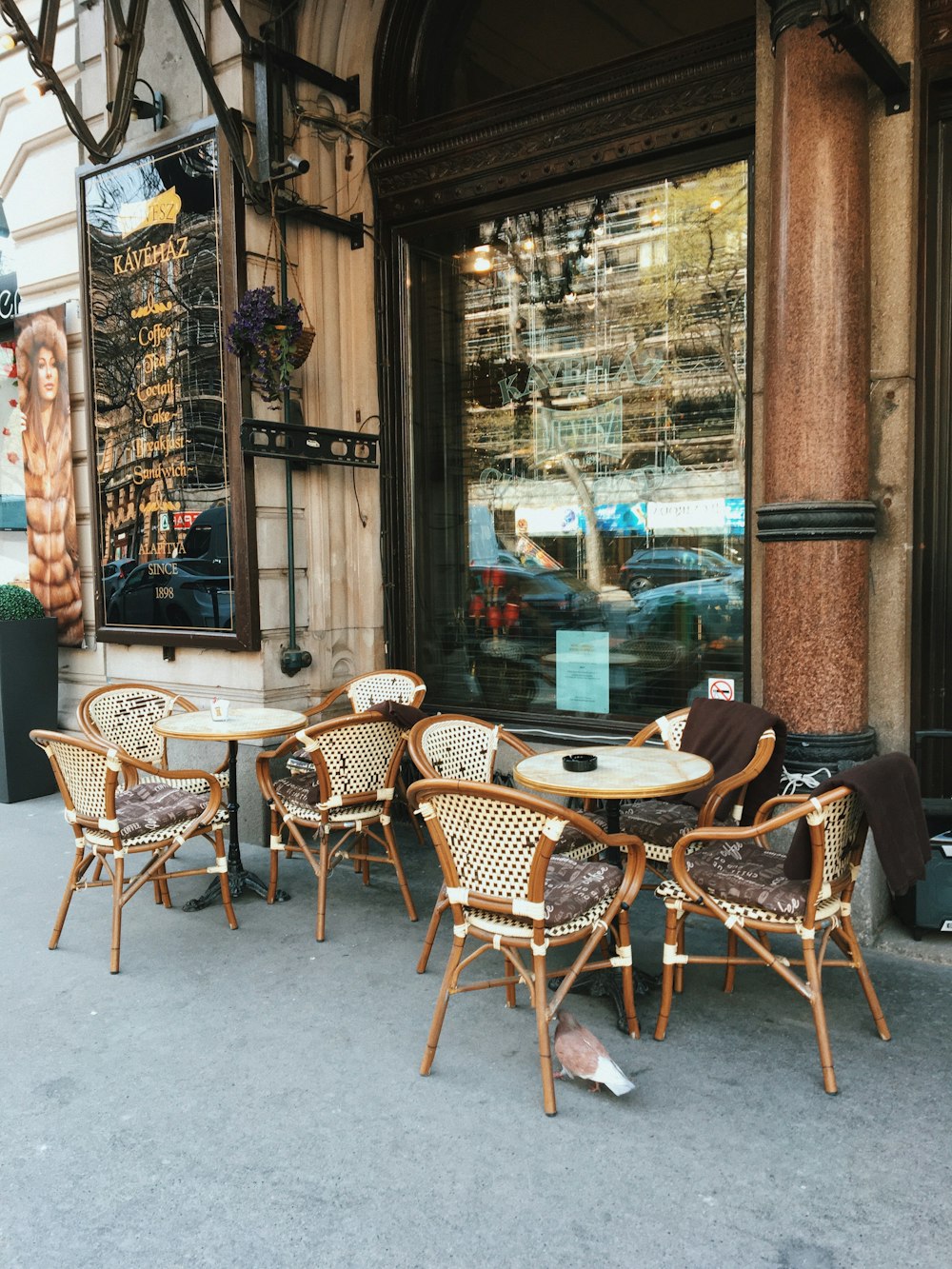 a group of chairs and tables outside of a building