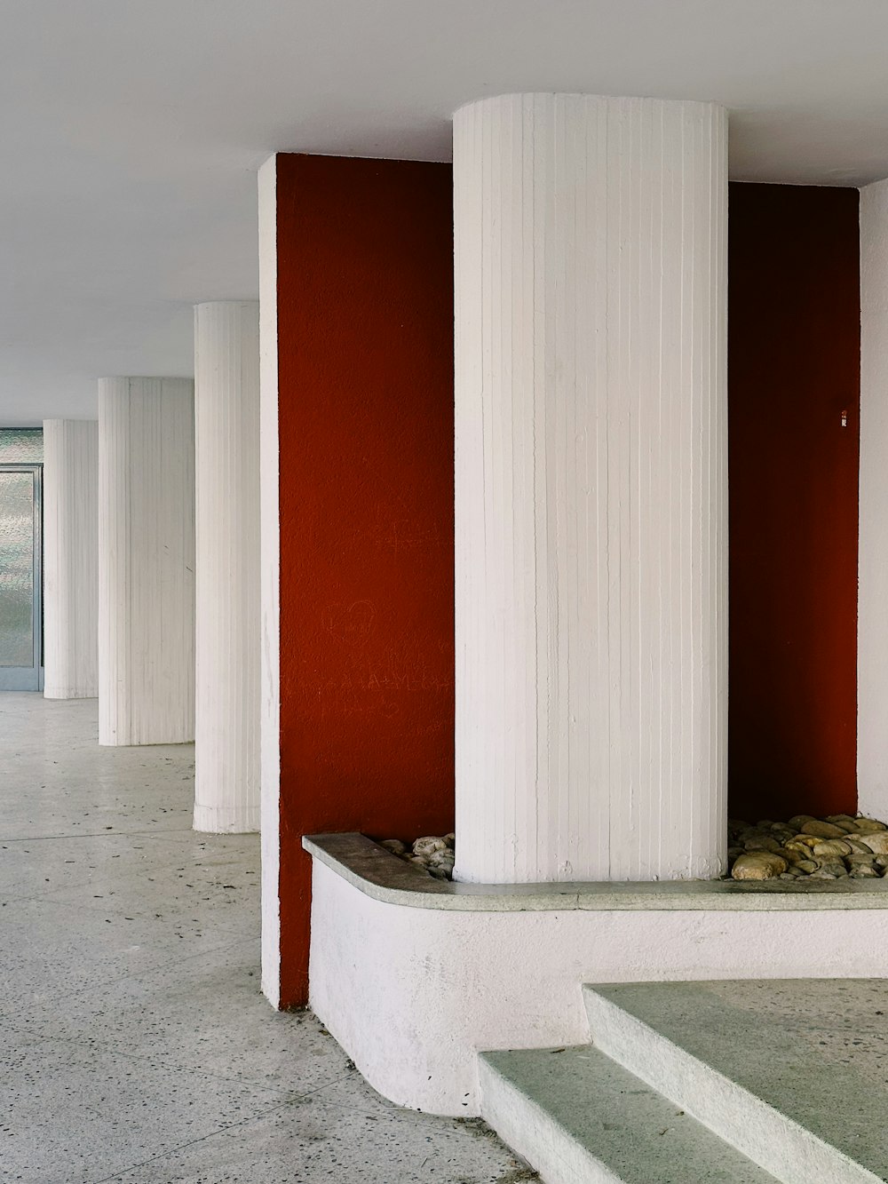 a room with red walls and white columns