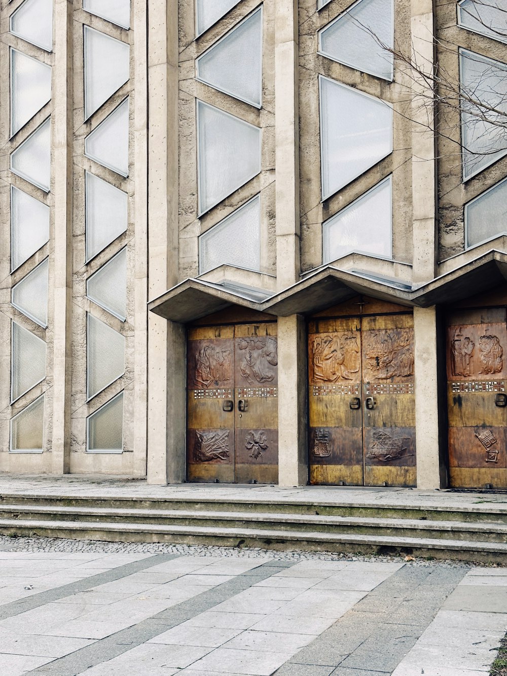 a couple of wooden doors sitting in front of a building