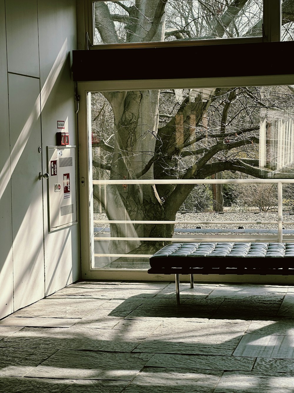 a bench sitting in front of a large window
