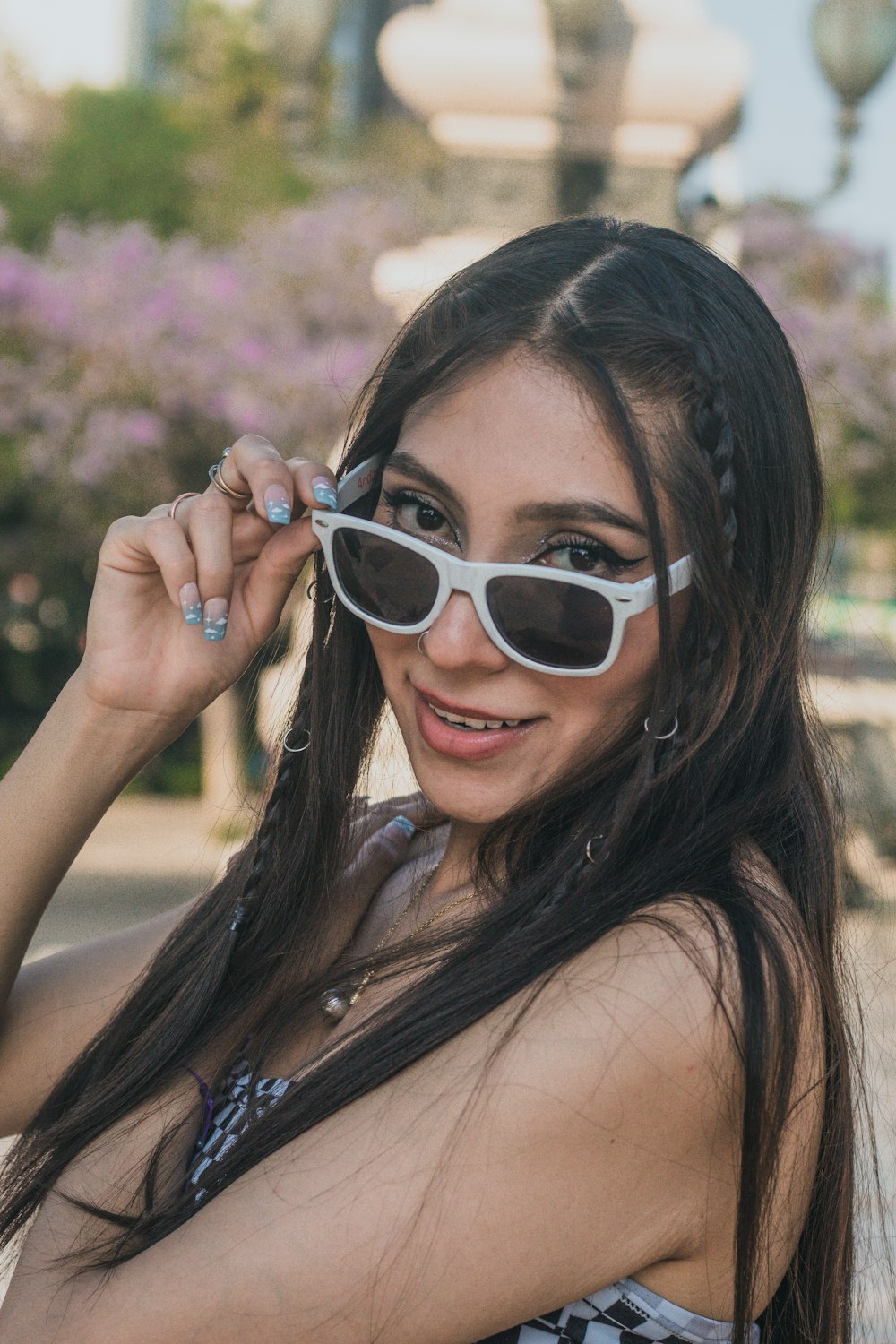 a woman wearing sunglasses posing for a picture