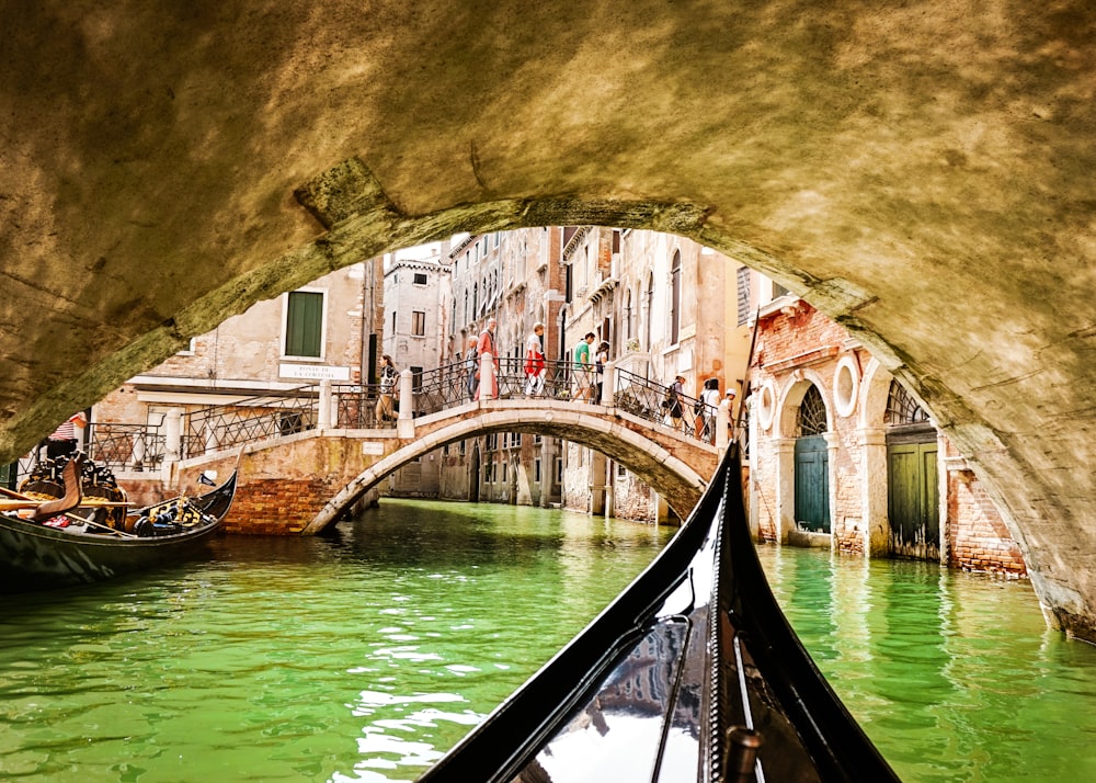 a gondola going under a bridge in venice
