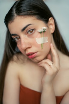 a woman with a piece of paper on her face