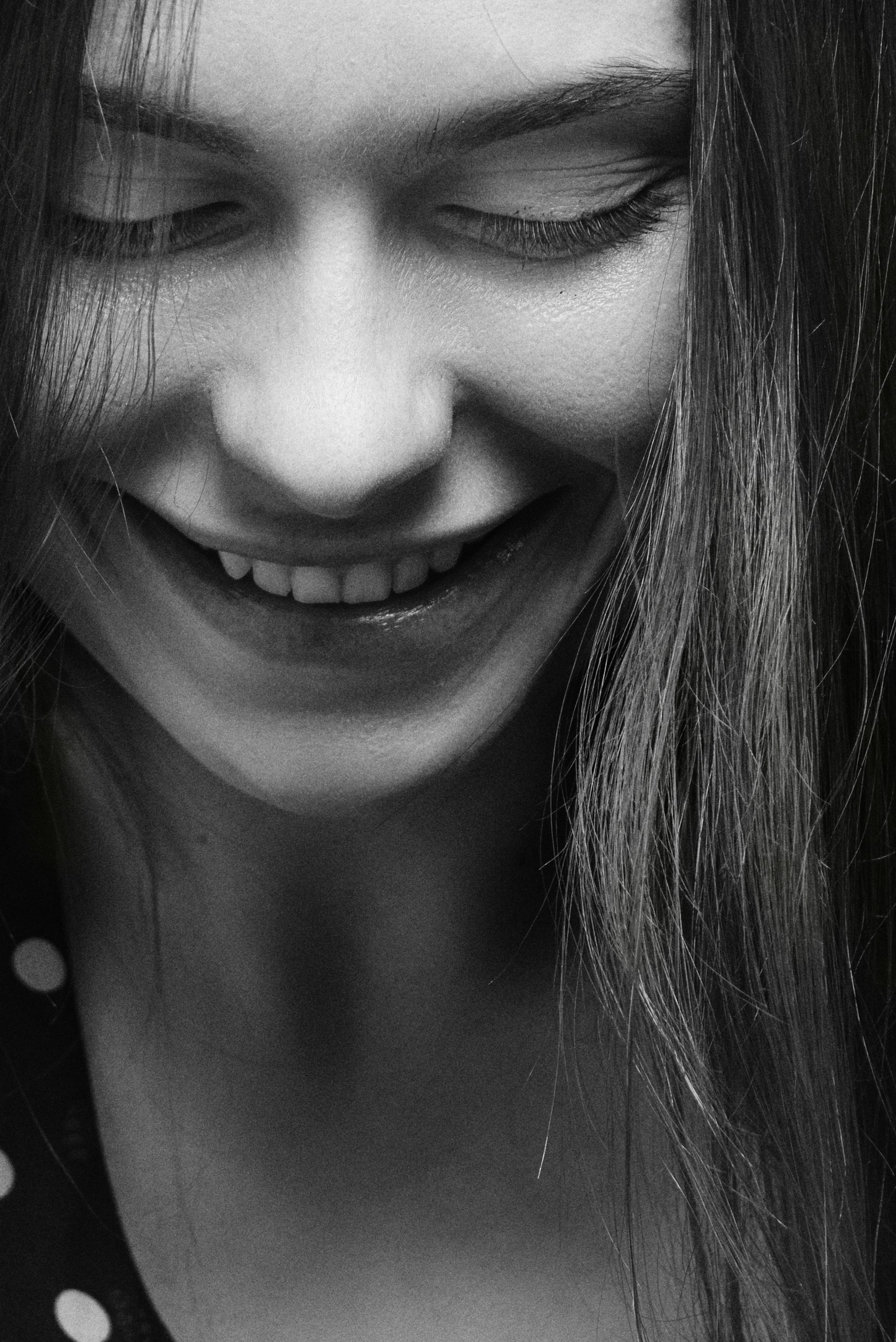 a black and white photo of a woman smiling