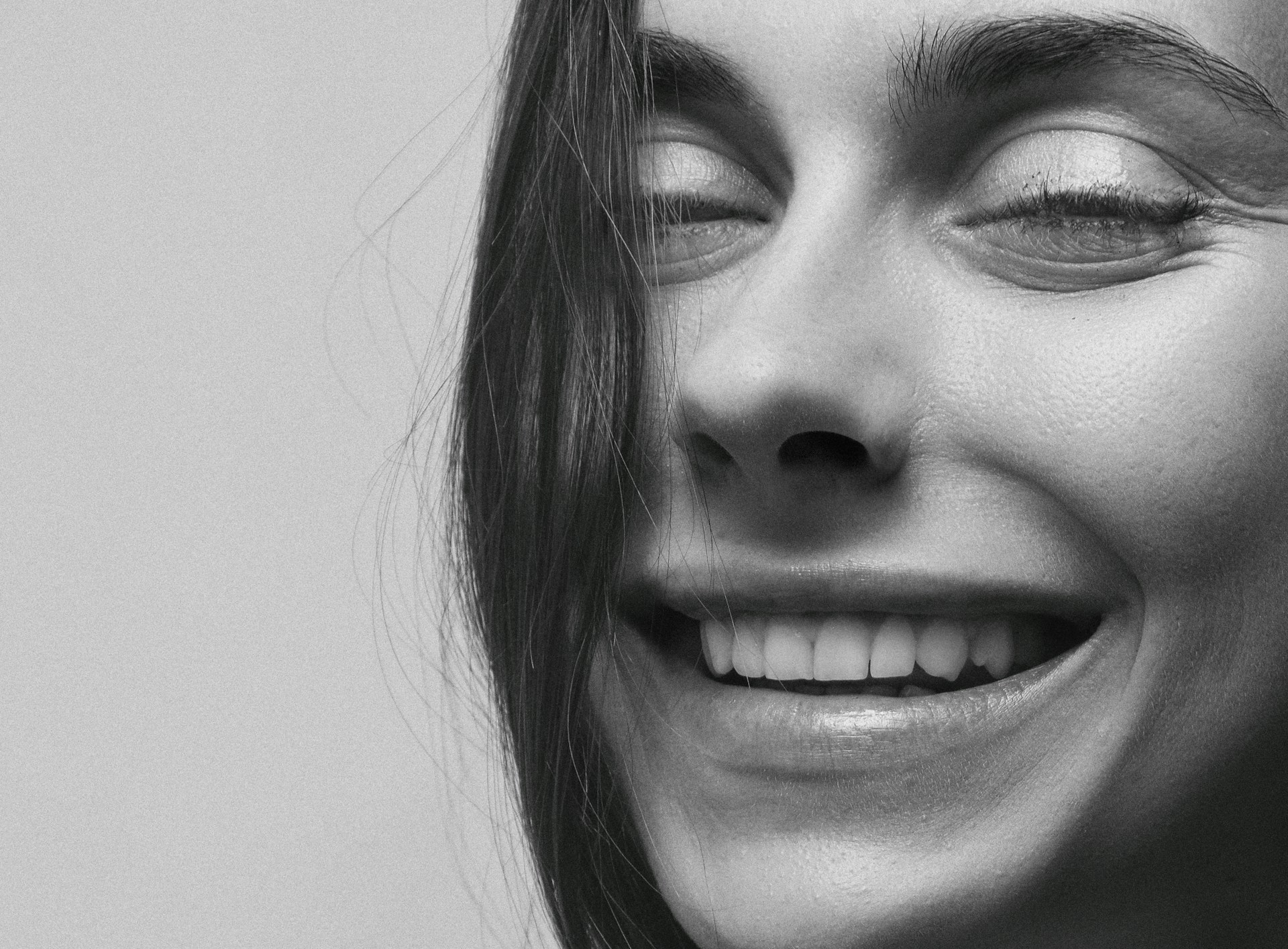 A close-up portrait of a smiling woman, capturing the essence of joy and natural beauty.