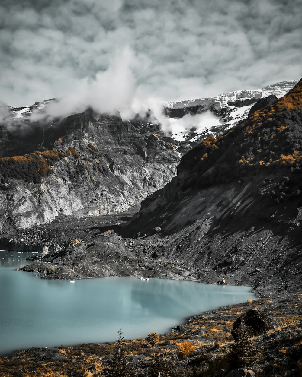 a mountain range with a lake in the foreground