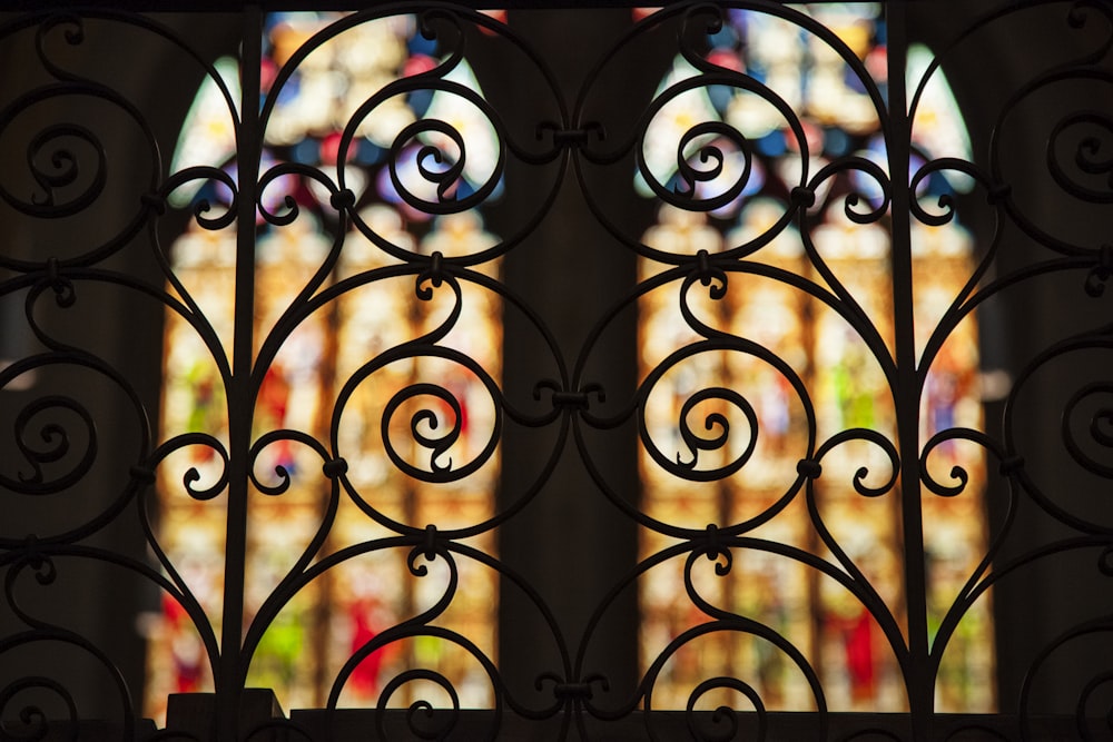 a close up of a window with a stain glass behind it