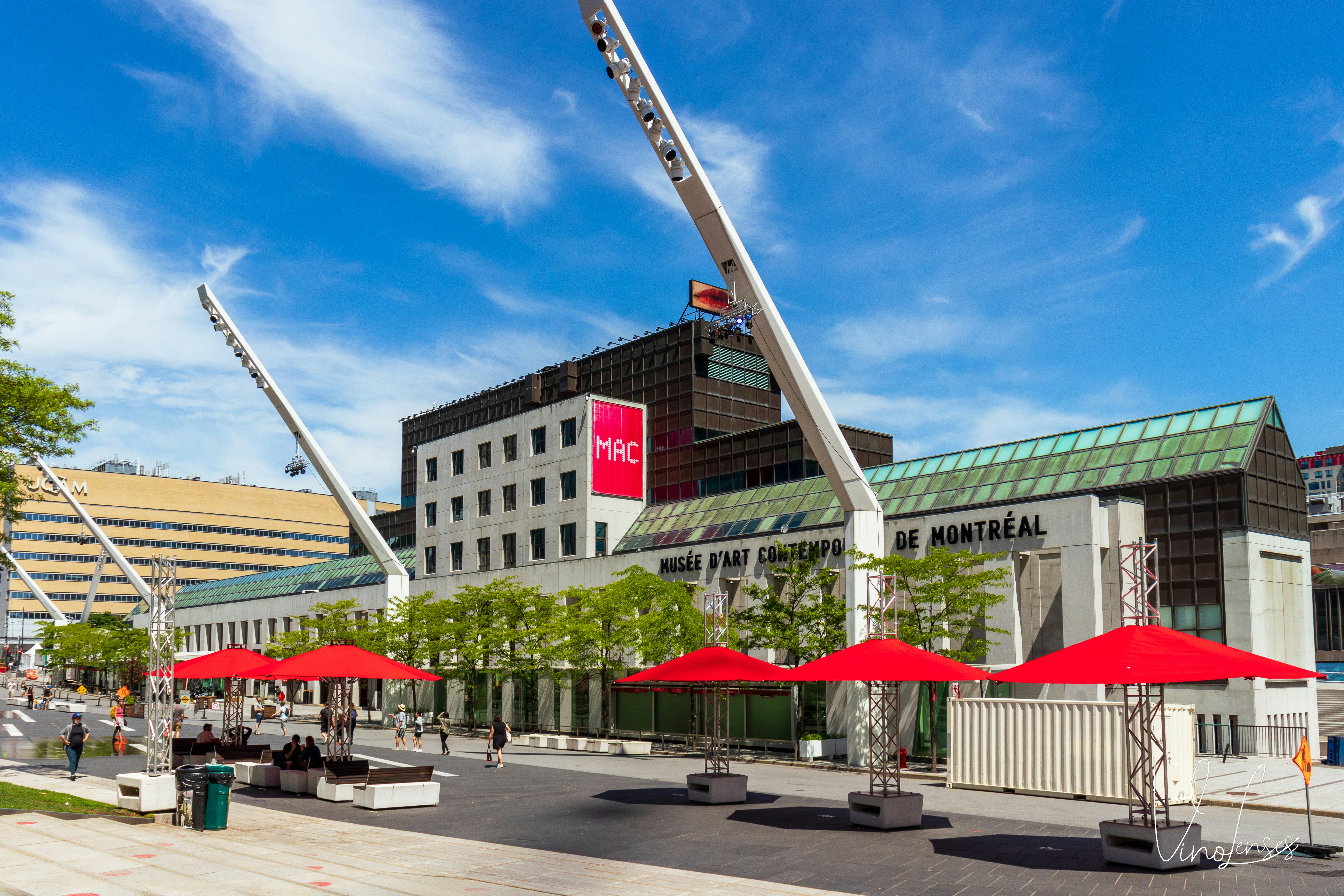 a building with red umbrellas in front of it