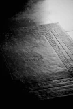 Black and white image of a book package with the physical book in warm color tones.