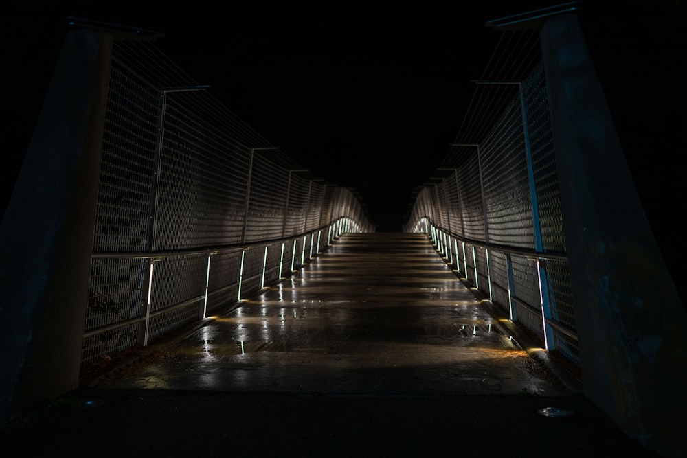 a long walkway with a light at the end of it