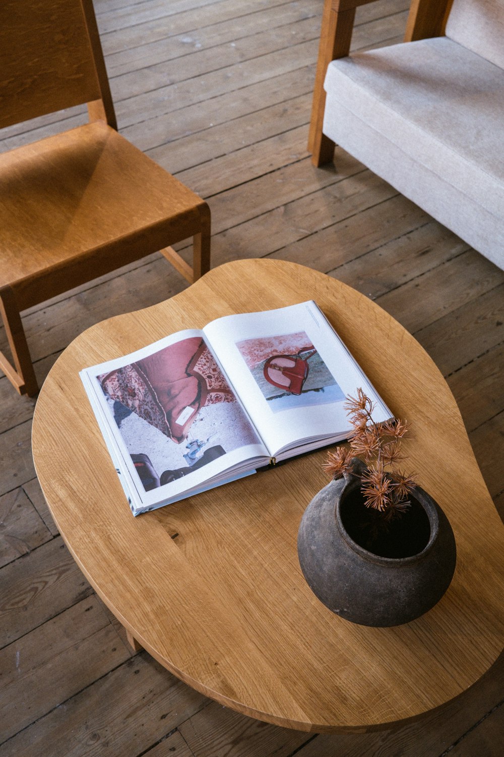 an open book on a table with a potted plant