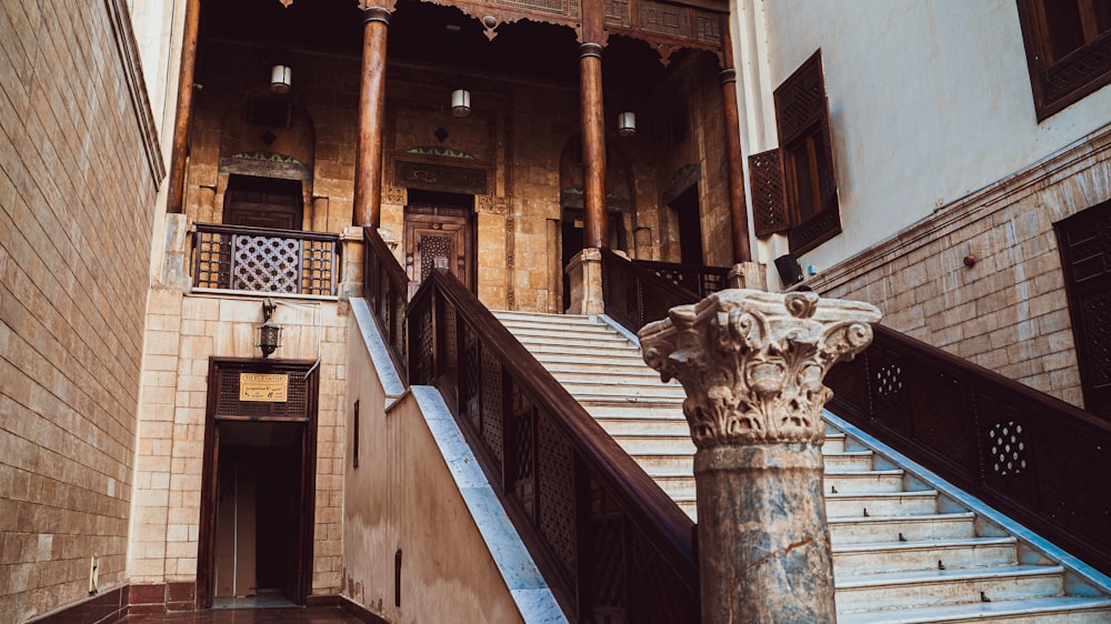 a staircase in a building with a stone column