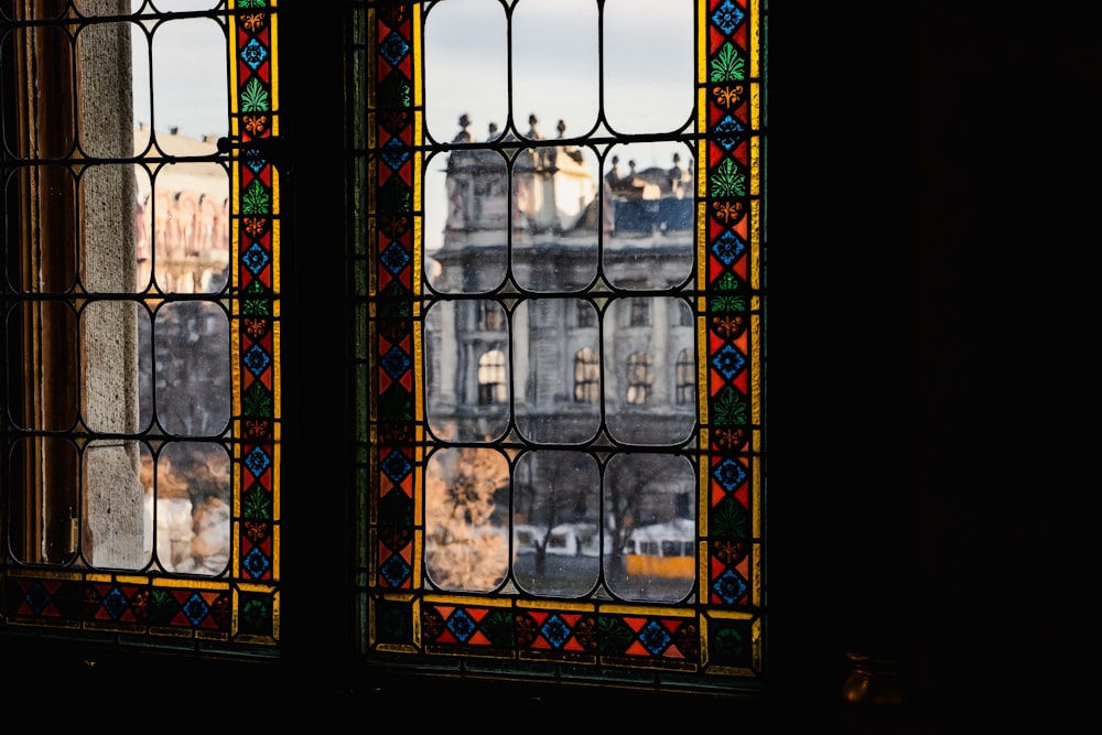 two stained glass windows with a view of a city