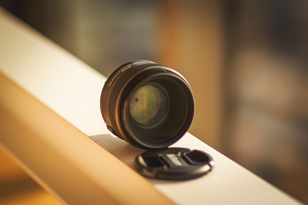 a camera lens sitting on top of a window sill