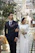 Elegant couple celebrating their wedding in a beautifully decorated outdoor event space with golden lighting and tropical plants.