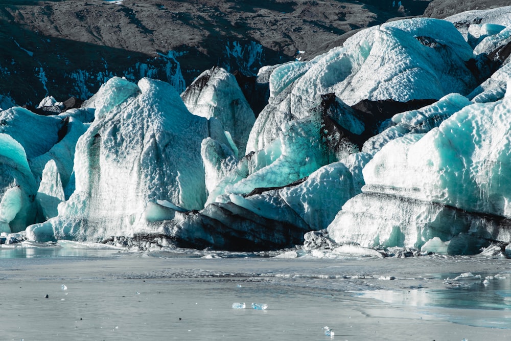 a group of icebergs that are in the water