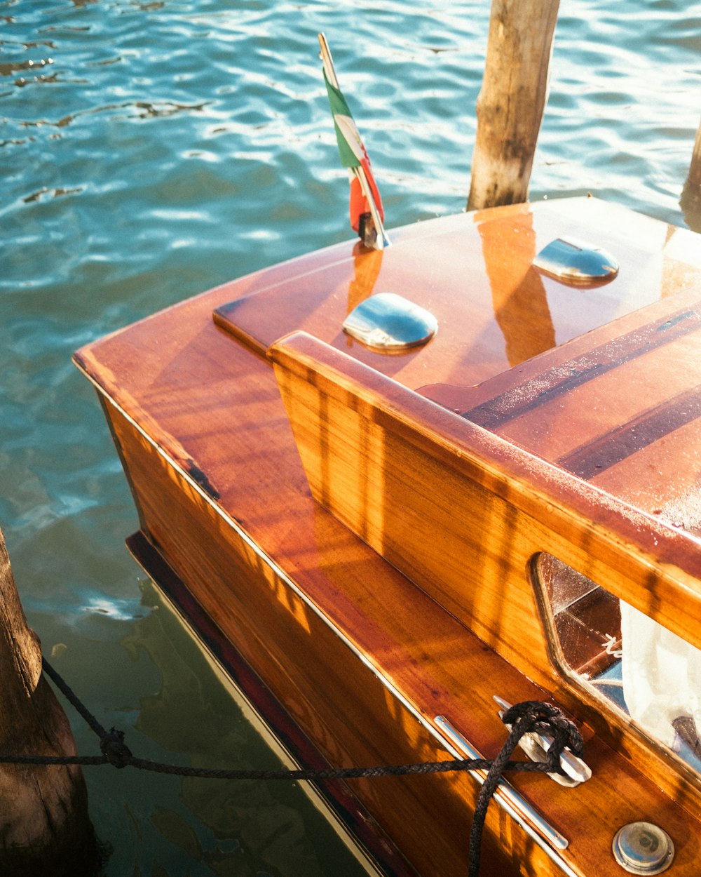 a small wooden boat tied to a dock