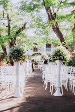 A wedding coordinator gently guiding the bridal party through the ceremony setup outdoors.