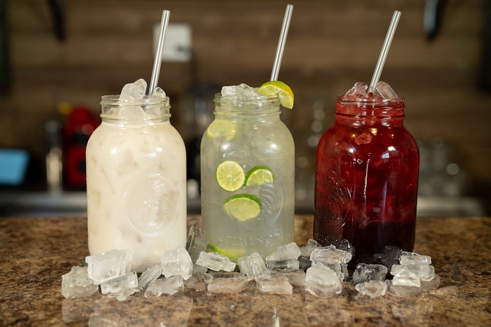 three different types of drinks sitting on a counter