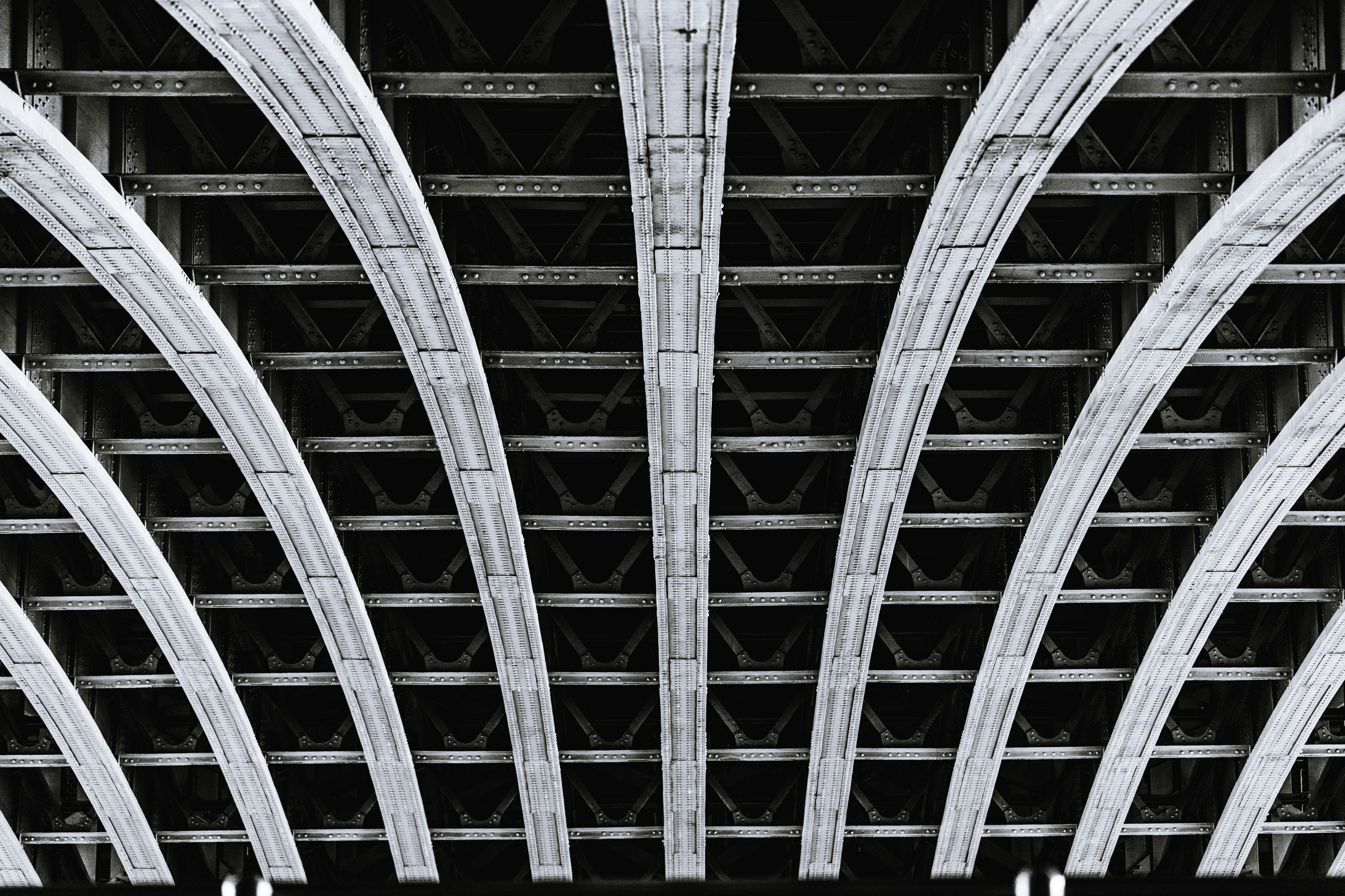 a black and white photo of a train bridge
