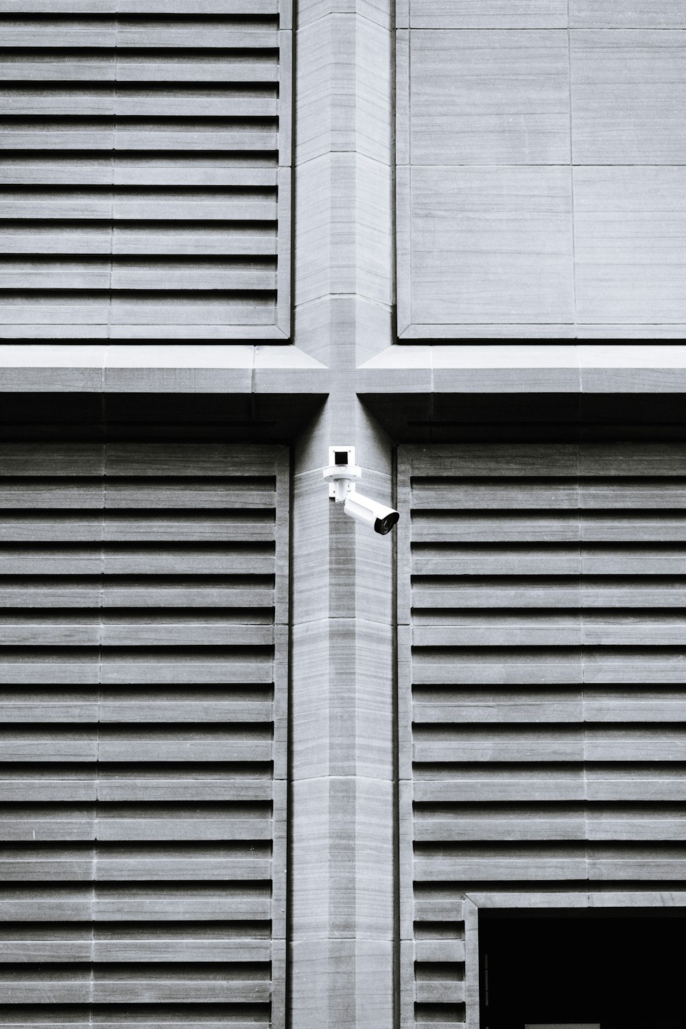 a black and white photo of a clock on a building