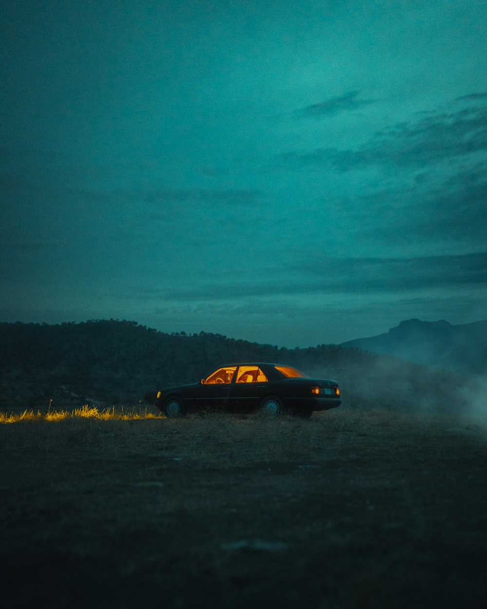 a car is parked in a field at night