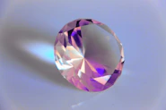 a close up of a pink diamond on a white background