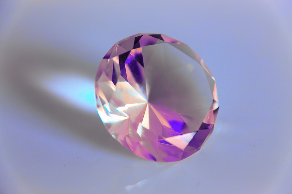 a close up of a pink diamond on a white background