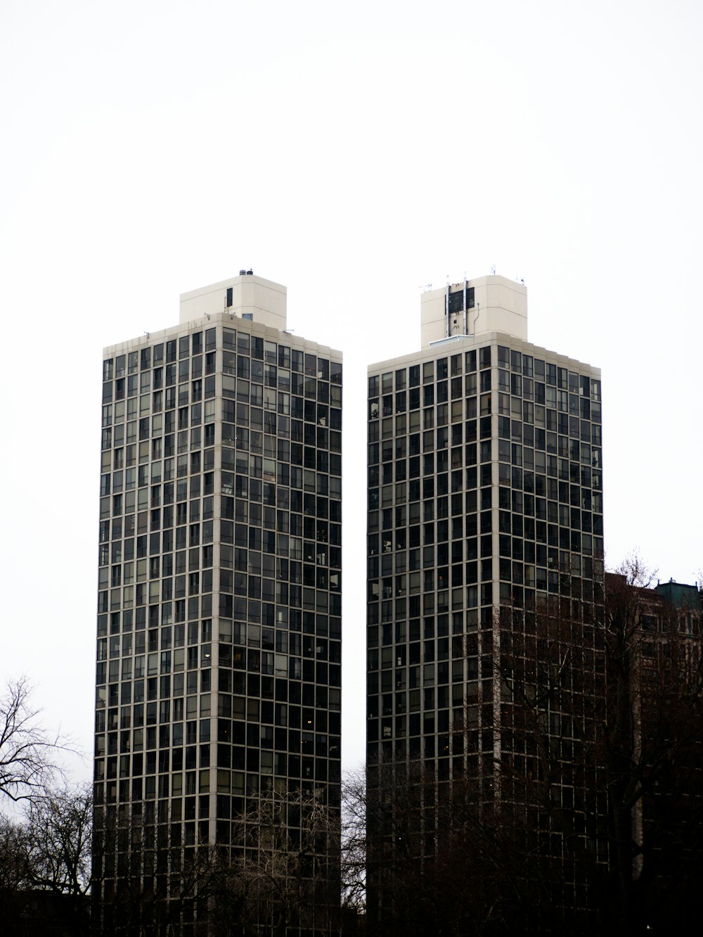 a couple of tall buildings sitting next to each other