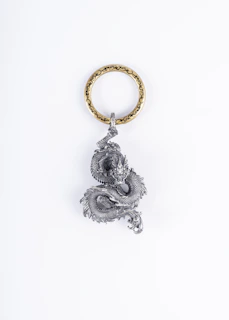 a key chain with a buddha statue on it