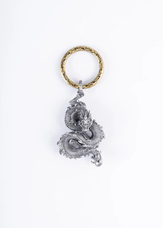 a key chain with a buddha statue on it
