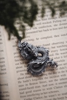 An intricate dragon sculpture curling around an ancient book.