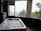 A serene loft with a round tub overlooking a lush forest.