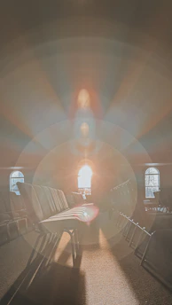 Soft rays of natural light gently illuminating a serene memorial space with elegant golden accents.