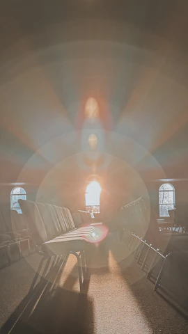 Evening session with warm cream and gold lighting illuminating the spiritual space