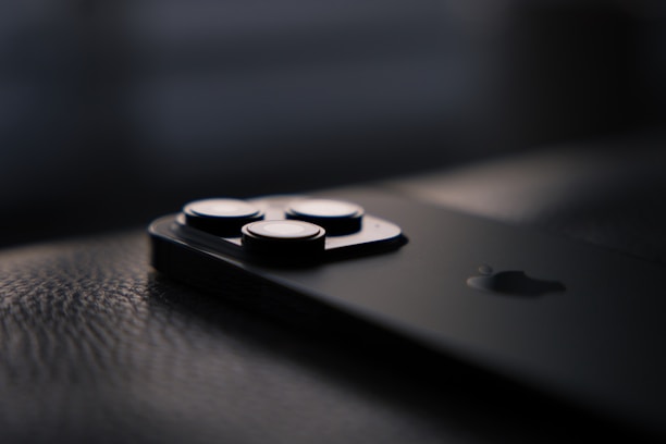 A close-up of a modern smartphone with a sleek design on a wooden table.